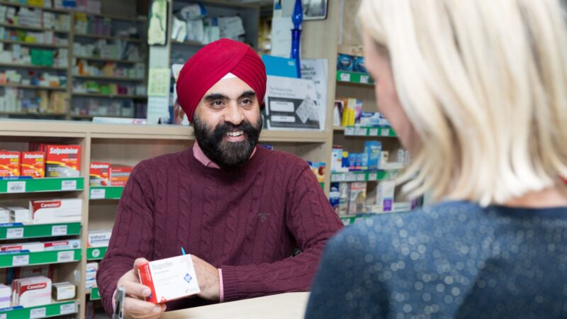 A pharmacist with customer