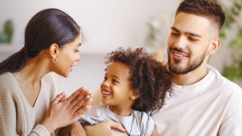 Parents with a young child smiling