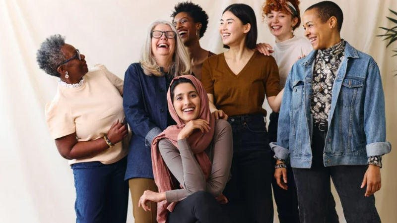 A group of women of various ages and ethnicities laughing together